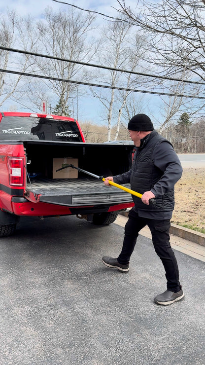 Man pulling a box to the tailgate of a pickup with the Cargo Pro Hook, standing on the ground